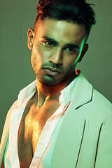 Image showing Skincare, wellness and man in studio with neon, green and light for beauty, health and grooming on a green background. Face, skin and indian model on creative mockup for product, sexy and aesthetic