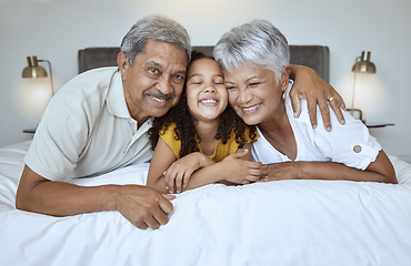 Image showing Love, bonding and mature people with child bonding while relaxing on the bed at home. Grandmother, grandfather and grandchild resting with affection and bond in their house bedroom for loving oomfort