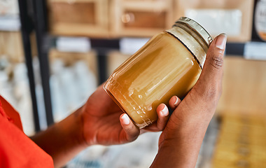 Image showing Shopping, peanut butter in hands and grocery store customer decision for sale product, discount or market promotion. Supermarket, groceries and food in glass jar for eco friendly and vegan choice