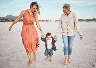 Image showing Beach, mother and grandma with boy holding hands having fun, bonding and walking. Family, care and grandmother, mom and kid or child enjoying holiday time together outdoors on sandy seashore or coast