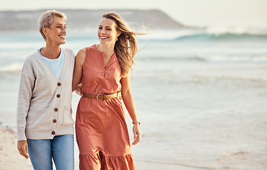 Image showing Beach, happy and mother walking with her daughter for wellness, exercise and bonding while on holiday. Happiness, smile and women embracing while on walk in nature by the ocean together in Australia.