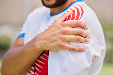 Image showing Sports, soccer and hands of man with shoulder pain from training game, soccer field accident or fitness exercise workout. Athlete emergency, injury problem and hurt football player with muscle strain
