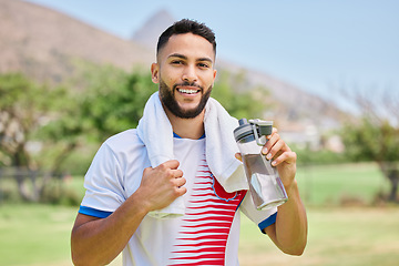 Image showing Portrait, fitness and soccer player drinking water in training, cardio exercise and football field workout. Happy, sports and healthy man relaxing and enjoying a resting break with a liquid beverage