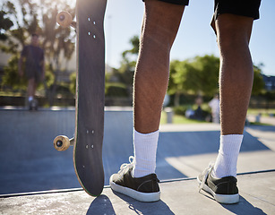 Image showing Skateboard, man and sports at skate park with concrete floor for fitness, exercise and freedom while outdoor for travel, hobby and training. Male with sneakers for skating at urban community course