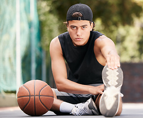 Image showing Portrait, basketball and man stretching legs for flexibility, wellness or mobility. Sports, fitness and basketball player on basketball court ready for training, exercise or workout, match or game.