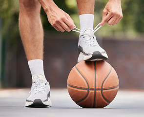 Image showing Basketball, athlete with shoelace, shoes and sport on basketball court outdoor, fitness and exercise motivation. Man, basketball player and ready for game, training and active with cardio and sports.
