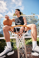 Image showing Basketball, sports and man on basket with ball for fitness, exercise and training workout at a community park with sports sneakers. Basketball player, urban court and game with male athlete thinking