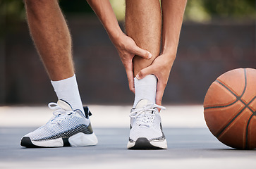 Image showing Legs, pain and sport injury with basketball and athlete on basketball court outdoor with emergency and fitness. Basketball player hurt, shoes and exercise with accident during match and workout.