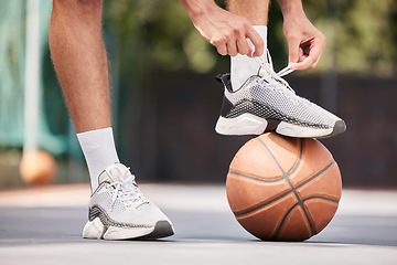 Image showing Tie shoes, sports and hands on a basketball court getting ready for training, cardio workout and fitness exercise. Footwear, sneakers and healthy athlete in preparation for a practice game or match