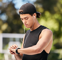 Image showing Fitness, time and man with smartwatch to monitor running workout, exercise and training performance or progress. Wellness, sports and healthy athlete checking his heart rate, pulse or cardio results