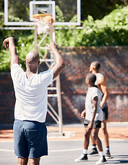 Image showing Basketball player, score and point in sports game for goal, victory or winning throw at the court outdoors. Man in basketball sport playing, scoring and perfect long shot for match outside