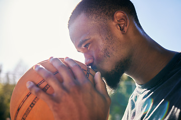 Image showing Black man, basketball and kiss for sports love, passion or dedication in motivation, good luck or praise on the court. African American male basketball player kissing lucky ball for score or point