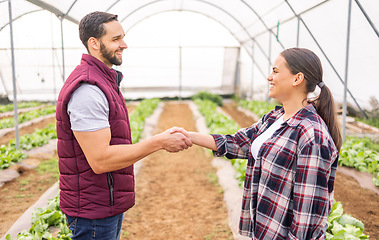 Image showing Partnership, agriculture and farmers doing handshake in greenhouse for business deal in farming industry. Collaboration, teamwork and man and woman shaking hands to work together on sustainable farm