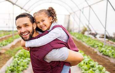 Image showing Greenhouse farmer, dad with girl and happy smile of girl getting piggyback ride from father in an organic farm for sustainable crop growth. Healthy food produce, natural crops and modern agriculture