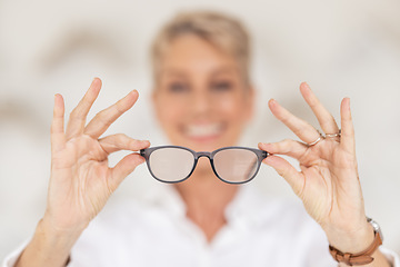 Image showing Vision, eyesight and glasses in hands with blur, woman has poor eye sight holding spectacles in blurred background. Healthcare, medical insurance and eyes, prescription lens in clear spectacle frames