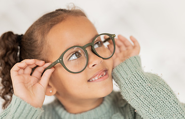 Image showing Child, glasses and eye care for vision, focus and concentration while wearing quality lens frame optician choice. Face of girl looking happy about optics fashion mockup for eyesight correction