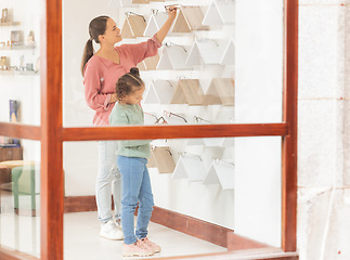 Image showing Eyewear, vision and family with a mother and daughter in an optometry store shopping for prescription lenses together. Family, retail and glasses with a woman customer buying spectacles for a girl