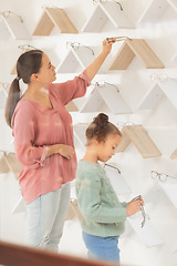 Image showing Eyewear, child and mother shopping for a frame together in a retail optometry, optician or eye care store. Spectacles, vision and mom choosing eyewear with her daughter for eyesight in a optical shop