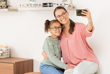 Image showing Mother, girl and phone selfie at optometrist, glasses and smile for eye vision, eyesight and social media picture for new lense frame. Woman, child and happy with eyeglasses or 5g mobile smartphone