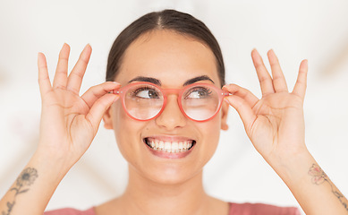 Image showing Vision, eyesight and woman putting on glasses with smile holding spectacles on face. Healthcare, medical insurance and eyes, happy girl with trendy prescription lens in spectacle frame at eye exam.