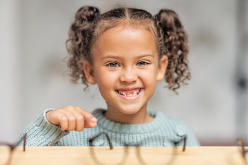 Image showing Optics store, child and smile for glasses choice for eye care, vision and focus while shopping for lens frame and pointing. Portrait, face and smile of girl customer making decision in optometry shop