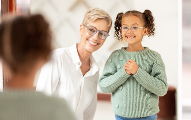 Image showing Store, shopping and vision with girl and glasses for eye care and eye health buying frames in retail shop. Optometry, ophthalmology and child customer being helped with eyewear by optometrist