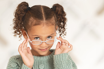Image showing Little girl, glasses and vision portrait with a child wearing eyeglasses in eyewear store for eye care. Optometry, ophthalmology and cute female child posing with spectacles and lenses in retail shop