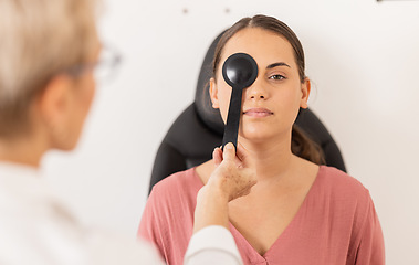 Image showing Woman, eye exam and vision test with occluder at optometrist for eyesight, glasses or checkup at the clinic. Doctor optician helping female patient eyes for optical sight in examination or testing