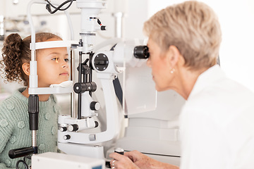 Image showing Optometry, vision and optometrist doing eye test on girl for optical care, wellness and health. Senior optician doing optic examination on child with autorefractor equipment in eyewear clinic or shop