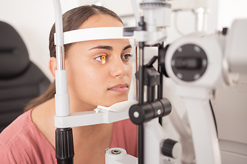 Image showing Vision, ophthalmology and woman in eye exam with light on iris at eye doctors office. Healthcare, medical insurance and eyes, girl getting healthy visual refraction eye test at ophthalmologist clinic