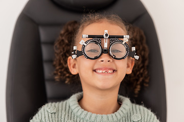 Image showing Trial frame, vision and eye test of girl at hospital or optometry clinic for eyewear, health and eye wellness. Exam, glasses and child testing eyesight for new optical lenses, frames or spectacles.