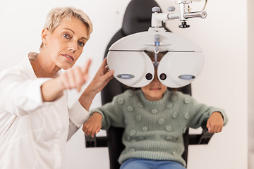 Image showing Vision, eye and test with a child at optometry exam with a specialist doctor in a clinic for glasses. Ophthalmology, optometry and medical expert eye test with little girl for eye health and eye care