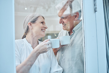 Image showing Love, coffee and window with senior couple relax, laugh and bond while looking cozy, happy and drinking coffee in their home. Glass, tea and elderly people enjoy retirement, quality time and rest