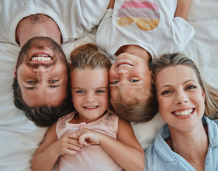 Image showing Happy family, love and above morning smile with parents and children lying and happy in bedroom for fun together at home. Laugh and man and woman love, care and happiness with girl kids to bond