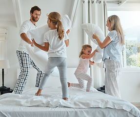 Image showing Family, children and pillow fight with parents and girl siblings having fun playing in a bedroom together. Kids, happy and bonding with a man, woman and daughter sisters playful with pillows on bed