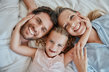 Image showing Happy, relax and portrait of family in bed with top view for wake up, support and smile together. Peace, bonding and connection with parents and girl lying at home for weekend, care and lifestyle