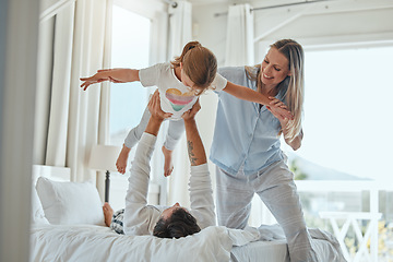 Image showing Family, mother and father lifting girl, playing and bonding in home bedroom. Love, support and happy man and woman holding child up in air, enjoying quality time together and having fun in house.