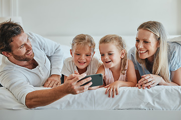 Image showing Family, bedroom and selfie for bonding and love while at home with a smartphone. Bed, phone and photo of happy parents relaxing in together for affection, loving and caring relationship in home
