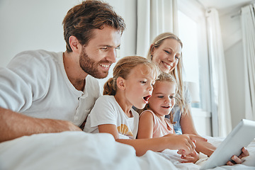 Image showing Tablet, children and family in bed with a mother, father and daughter siblings streaming online content together at home. Technology, kids and love with a man, woman and girl sisters watching series