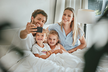 Image showing Morning, bed and happy family take a selfie with a smile enjoying quality time, bonding and relaxing at home. Pictures, mother and father with young children, kids or siblings in the house bedroom