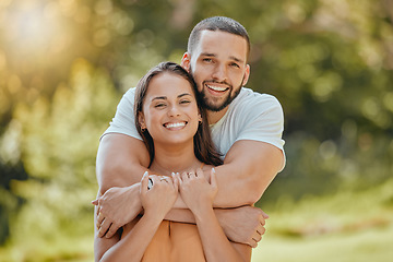 Image showing Couple, park hug and smile in nature feeling love, commitment and people together outdoor. Portrait of a happy girlfriend and boyfriend hugging with care for anniversary or engagement