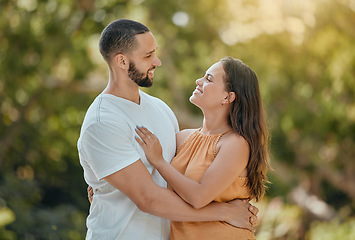 Image showing Happy, love and couple hug in a park, bond and talking and quality time against a nature, tree and bokeh background. Happy, smile and woman with man enjoying trust, support and relationship in forest