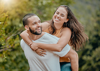 Image showing Love, fun and nature couple hug while playing, happy and enjoy outdoor quality time together in Toronto Canada park. Freedom peace, partnership trust and man piggyback woman on romantic bonding date