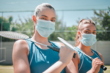 Image showing Women, badminton and covid mask of sport athlete team ready for an outdoors sports game. Teamwork, collaboration and exercise portrait of a woman and player with a racket in the sun for fitness