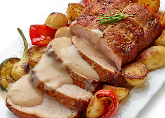 Image showing sliced roast pork with vegetables and sauce