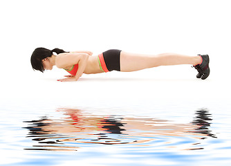 Image showing woman practicing four-limbed staff pose