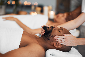 Image showing Spa, couple and massage for health and wellness at luxury resort for peace, calm and quiet time with hands of therapist in a beauty salon. Black man lying on bed for body, mind and head care at hotel