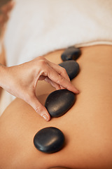 Image showing Hands, rock and spa for back massage in relax for healthy wellness, zen or physical therapy treatment at resort. Hand of therapist applying rocks in relaxation, stress relief and luxury care for skin