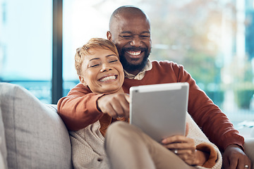 Image showing Couple, tablet and digital movie streaming of people on a home living room sofa with technology. Happy, relax and funny video watching of a woman and man on a home lounge sofa with love together