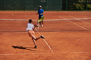 Image showing A professional tennis player and her coach training on a sunny day at the tennis court. Training and preparation of a professional tennis player